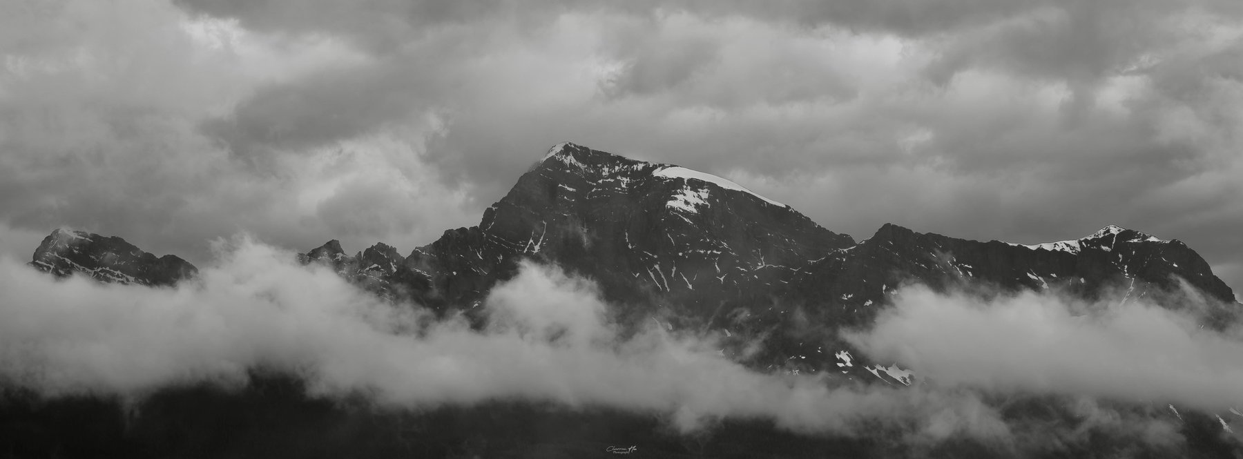 Mountain ridge wrapped in clouds, black and white